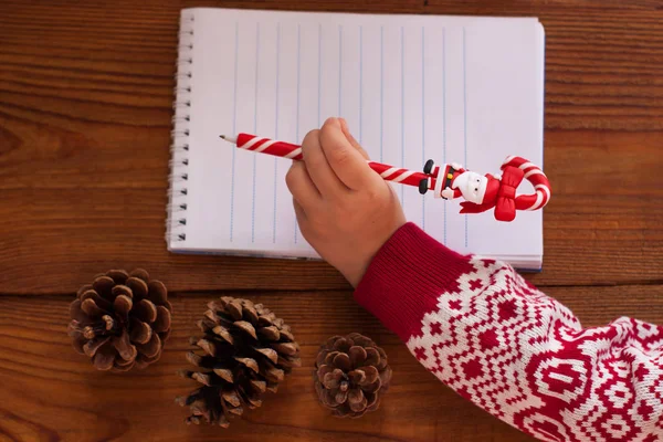 Dear Santa letter, child writes a Christmas card. Childhood dreams about gifts. New year concept.