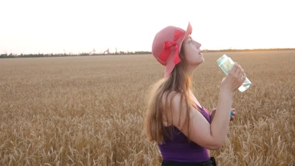 Vrolijk Jong Meisje Met Strohoed Drinkt Water Uit Fles Glimlacht — Stockvideo