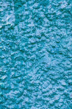 Eski turkuaz alçı duvar dokusu. Retro boyalı macun bina arka planında kopyalama alanı var. Şık mavi yüzey, ayrıntılı taşlar arka plan. Metin tasarımı için duvar kağıdı desenli ekran koruyucu öngörünümü.