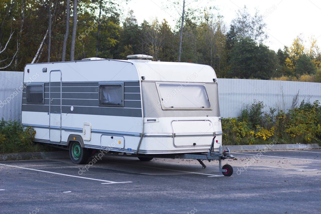 Movable property. Old abandoned motor mobile home for traveling, trailer, caravan parked in a parking lot. 