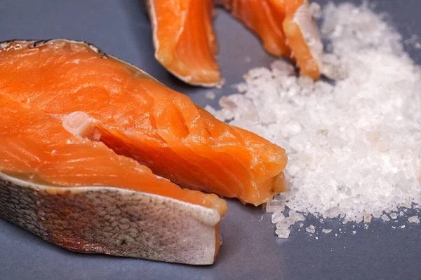 Sliced salted trout fish on a plate with salt — Stock Photo, Image