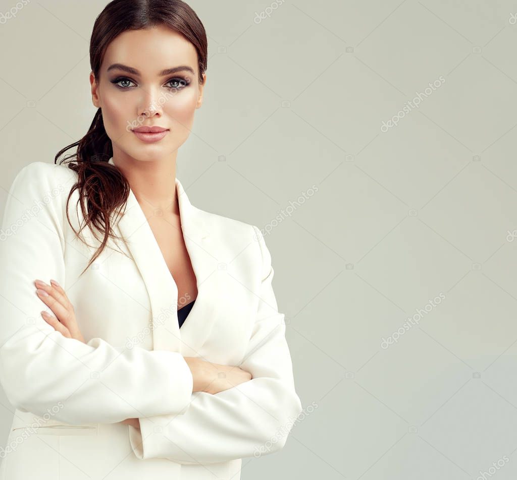 Young attractive woman dressed in a white suit jacket. Makeup and cosmetology.