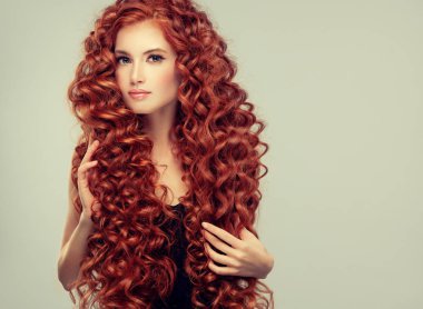 Beautiful model girl with red  curly hair  .Young woman with short wavy hairstyle