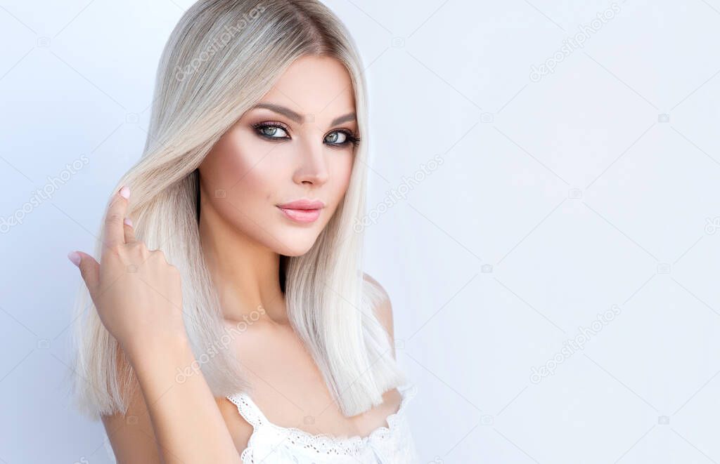 Beautiful girl with dyed hair in blond. Stylish hairstyle done in a beauty salon. Beauty, cosmetics and makeup