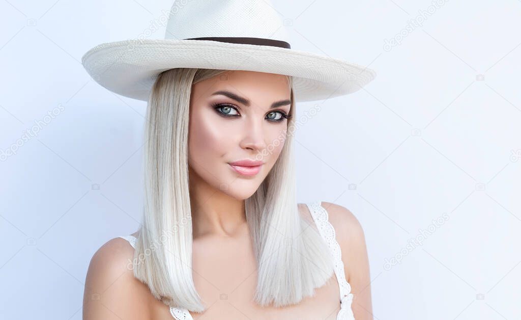 Beautiful  blond girl in hat. Stylish hairstyle done in a beauty salon. Beauty, cosmetics and makeup