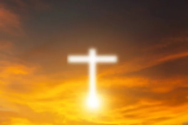 Conceptual wood cross or religion symbol shape over a sunset sky — Stock Photo, Image