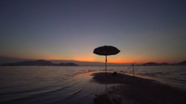 Footage B roll Scene of Sunset time at River with fishing boat and umbrella for relaxing. Beautiful nature and sunset twilight.