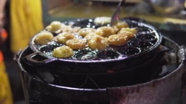 Footage B Roll of Thai style Takoyaki traditional coconut pancakes filled with minced or diced octopus, shrimp, vegetables. Asian street food on a frying pan in Bangkok. thai street food Takoyaki.