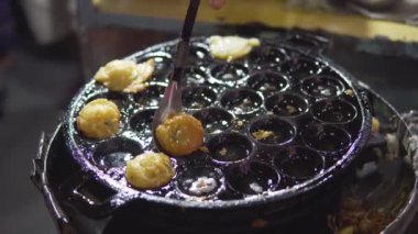 Footage B Roll of Thai style Takoyaki traditional coconut pancakes filled with minced or diced octopus, shrimp, vegetables. Asian street food on a frying pan in Bangkok. thai street food Takoyaki.