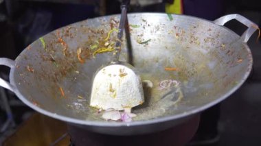 Footage B Roll of Pad Thai favorite and famous Asian Thai street fast food in hot pan, Chef are cooking Pad thai or noodle sauce Thai street food in the market Thailand. 