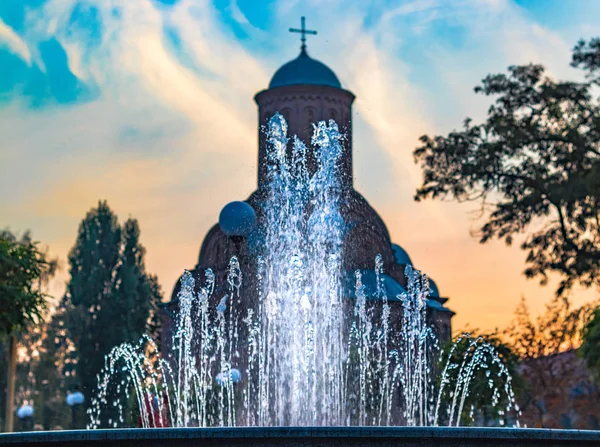 Water fountain fits in the contour of church