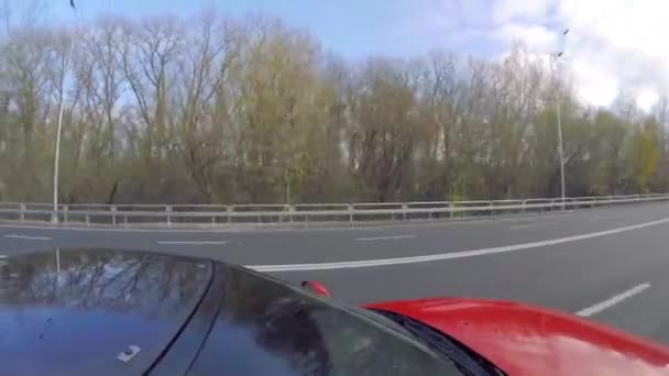Chernihiv, Ukraine. 3 apr 2019. Red race car cruising through the highway at middle spring day — Stock Video