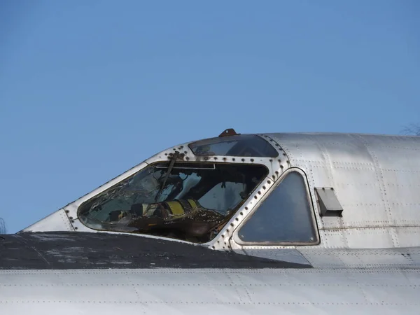 Old aircraft near, skin, parts and engine components.