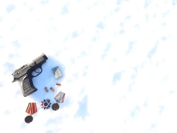 Een 9mm pistool en een kogel met handschoenen verspreid in de sneeuw. — Stockfoto