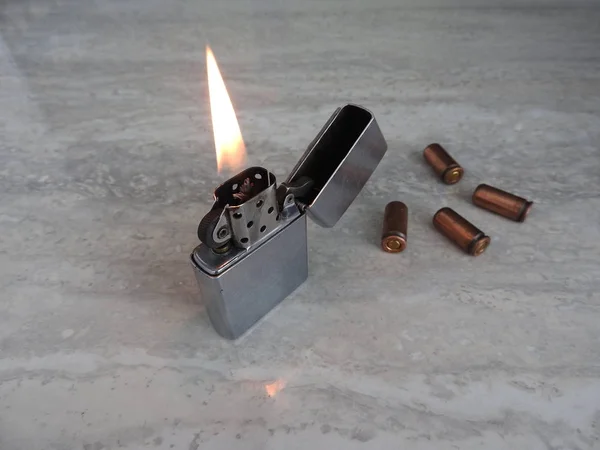 Open metal lighter with flame on black background. — Stock Photo, Image