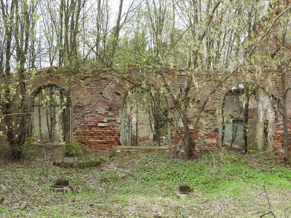 Ruiny staré Rudé cihlové a sádrové budovy na jaře ve vesnici Grebnevo poblíž Moskvy, Ruska. — Stock fotografie