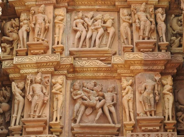 Erotic sculptures and sex poses of man in kajuraho temples, Madhya Pradesh, India. Built around 1050, it is a UNESCO world heritage site, a tourist destination. The concept of textures and postcards. — Stock Photo, Image