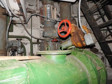 An abandoned prison in an underground bunker. A former Soviet cold war bomb shelter. The sealed door of the bunker. Pipes and valves. Low light condition. Bunker of fear and nightmares.