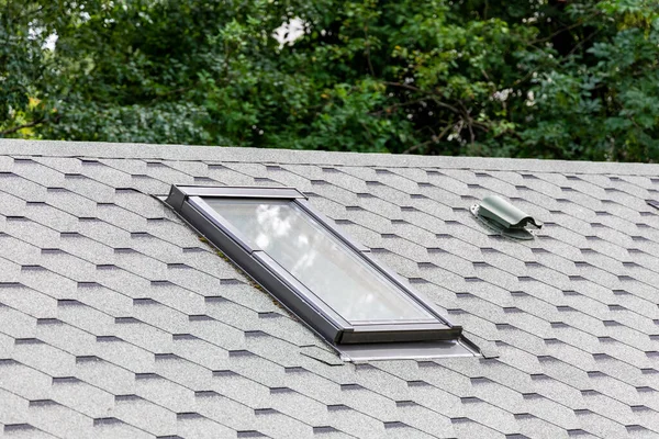 Window and ventilation system in roof of house. Selective focus