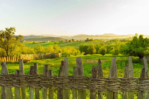 Old wooden fence. Serbia landscape. Mountain village in Europe. Summer day.