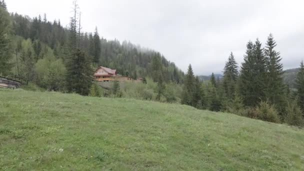 House in the mountains. Slow motion. Carpathians. Ukraine. Aerial. Gray, flat — Stock Footage House in the mountains. Slow motion. Carpathians. Ukraine. Aerial. Gray, flat Stock Video