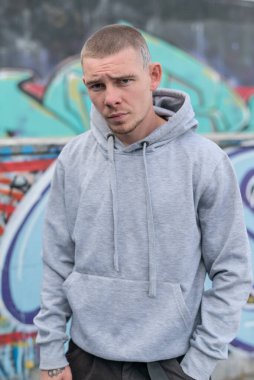 Kapüşonlu spor ceketli bir kabadayı.