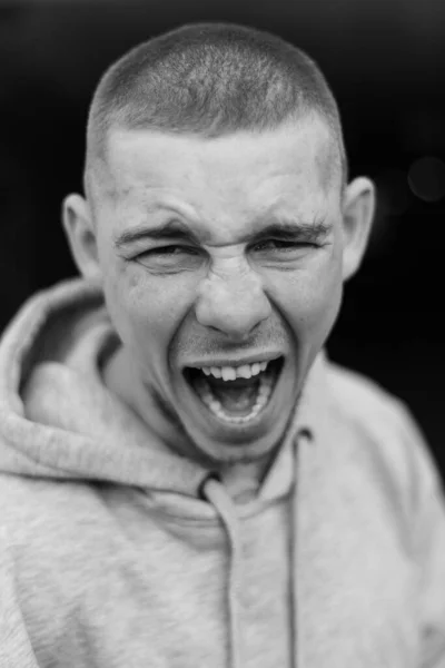 Un matón con una chaqueta deportiva ligera con capucha. Foto en blanco y negro. BW —  Fotos de Stock