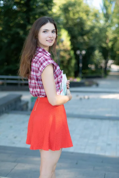Chica estudiante en falda roja y camisa a cuadros — Foto de Stock