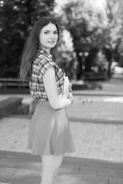 Chica estudiante en falda y camisa a cuadros. Foto en blanco y negro. BW —  Fotos de Stock