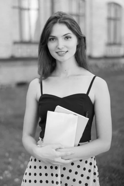 Young girl student in dress. Black and white photo. BW