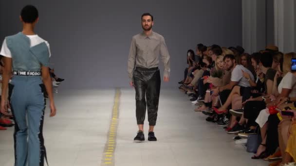 Modeshow. Mand model går på catwalken. – Stock-video