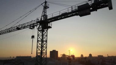Şafakta şehirde bir inşaat sahasında vinç. Kyiv, Ukrayna. Hava görünümü