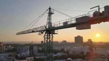 Şafakta şehirde bir inşaat sahasında vinç. Kyiv, Ukrayna. Hava görünümü
