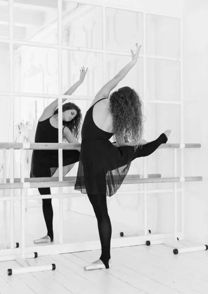 Girl ballerina with curly hair. Black and white photo. BW — Stock Photo, Image