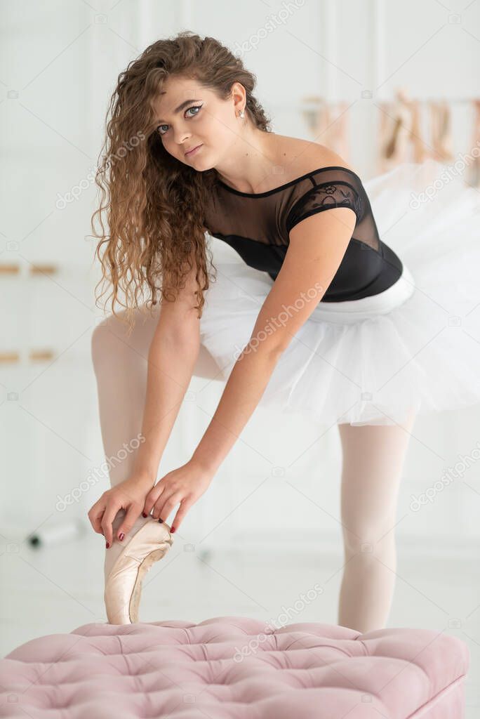 Young beautiful girl ballerina with curly hair