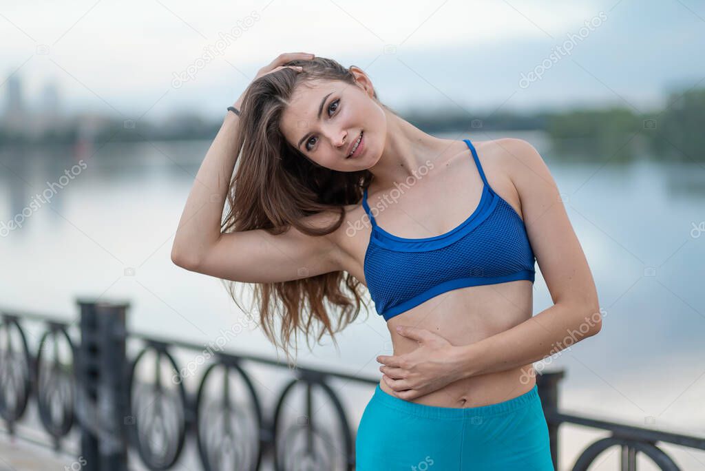 Sports and healthy lifestyle : Brunette girl doing sports exercises.
