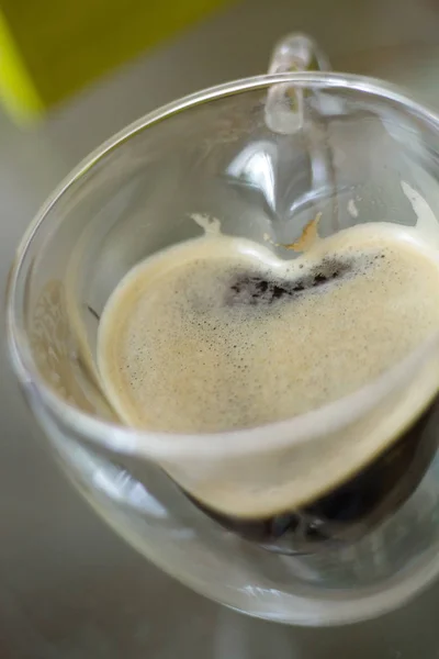 A cup of coffee in the shape of a heart. Mug heart. Coffee for cheerfulness. A cup of black coffee. top view, flat lay