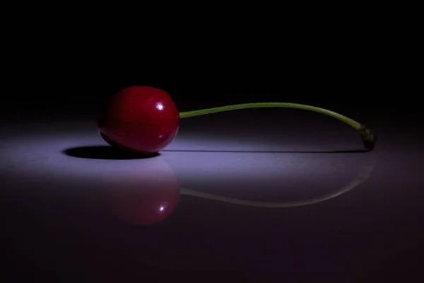 DELICIOUS RED CHERRY ON THE FLOOR