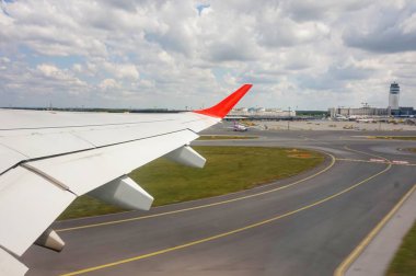 Kalkış uçağının kanadı. Aşağıda havaalanı.