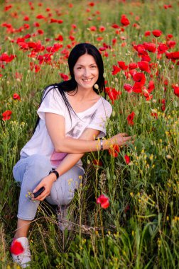 beyaz bir t-shirt ve mavi jea uzun koyu saçlı genç bir kız