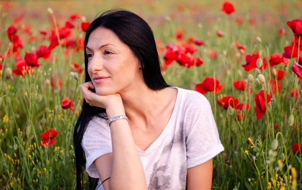 A young girl with long dark hair in a white T-shirt and blue jea — Stock Photo, Image