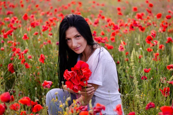 A young girl with dark long hair is wearing a blouse T-shirt and — Stock Photo, Image