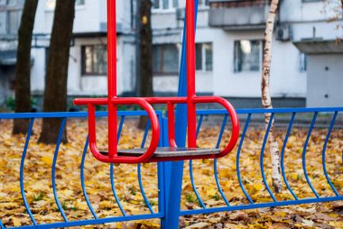 Çimenler üzerinde renkli sonbahar sarı yaprakları arasında Çocuk salıncak.