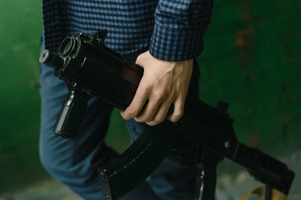 People play laser tag. Weapons in the hands of people. A game of laser tag among children. man takes aim from a weapon