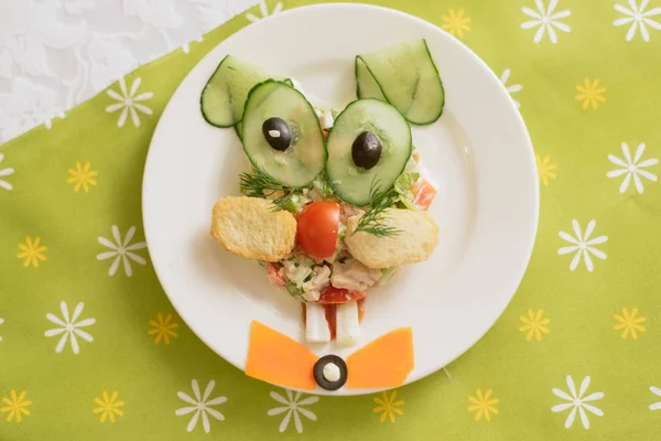 stock image Creatively decorated salad in the form of a hare. Children's menu on a green background