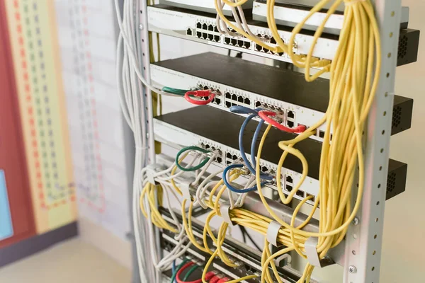 fiber optic in server room close up. Many wires connect to the network interfaces of powerful Internet servers.  Children\'s server equipment for games.
