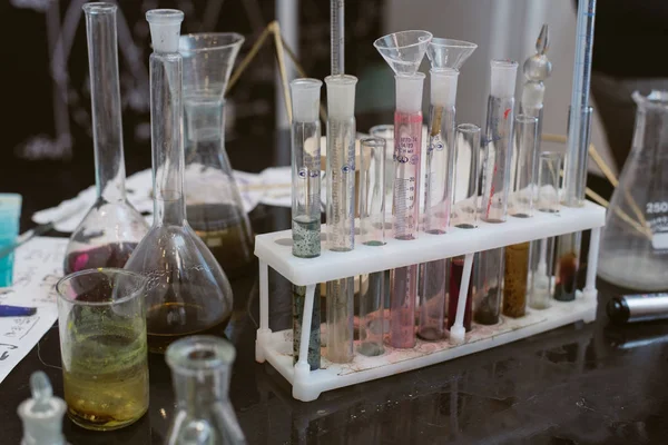 dirty flasks. Chemical laboratory and a shelf with bottles on the background of physical formulas.