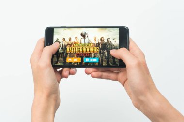 Samara, Rusya -07, 29, 2019: Genç bir adam Iphone 8 Plus'ta Pubg oyunu oynuyor. Beyaz bir arka plan üzerinde bir oyun Playerunknown's Battlegrounds ile elinde bir telefon tutan genç çocuk