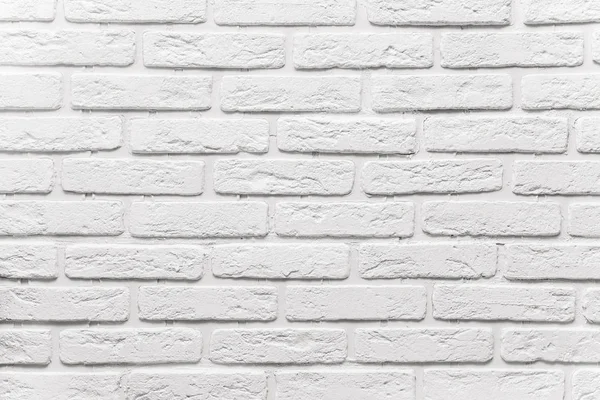 long white brick wall. The texture of the old brick painted with white paint