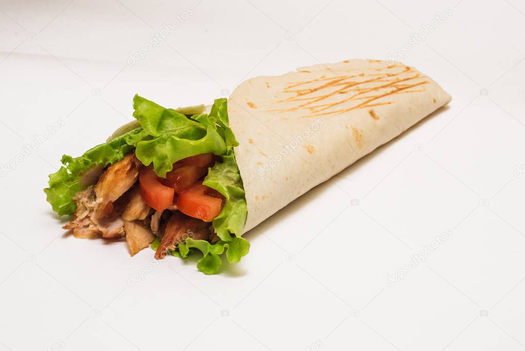Isolated shawarma with a shadow. Oriental food made from chicken meat, tomatoes, cucumbers in pita bread
